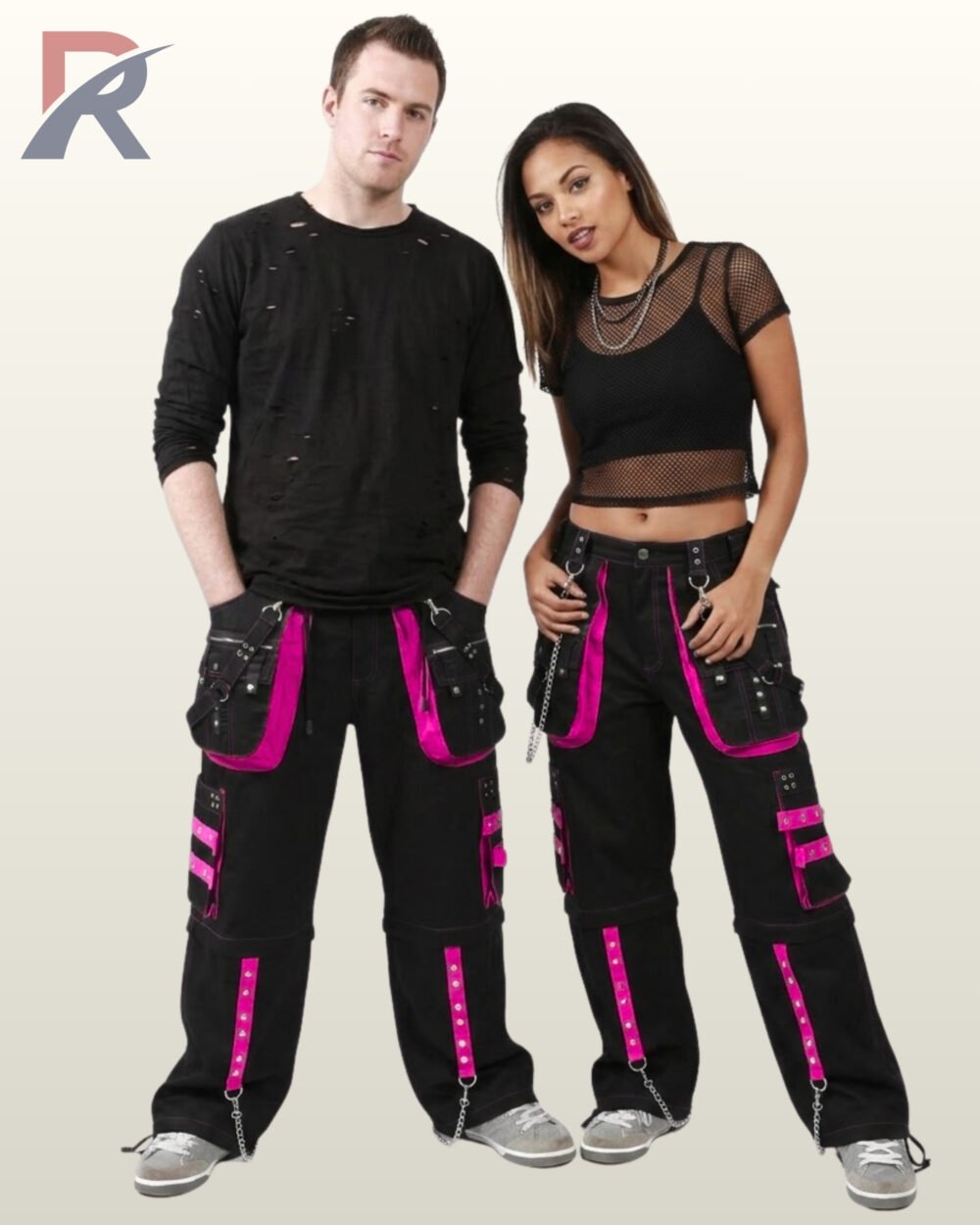 Couple in dark alternative wide-leg trousers highlighting magenta hot pink studded trim and metal D-ring hardware.