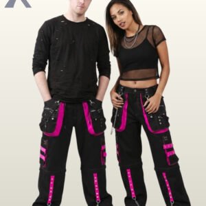 Couple in dark alternative wide-leg trousers highlighting magenta hot pink studded trim and metal D-ring hardware.