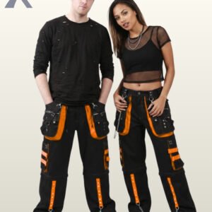 Man and woman modeling wide-leg alternative techwear pants detailed with vibrant orange studded trim and silver chain accents.