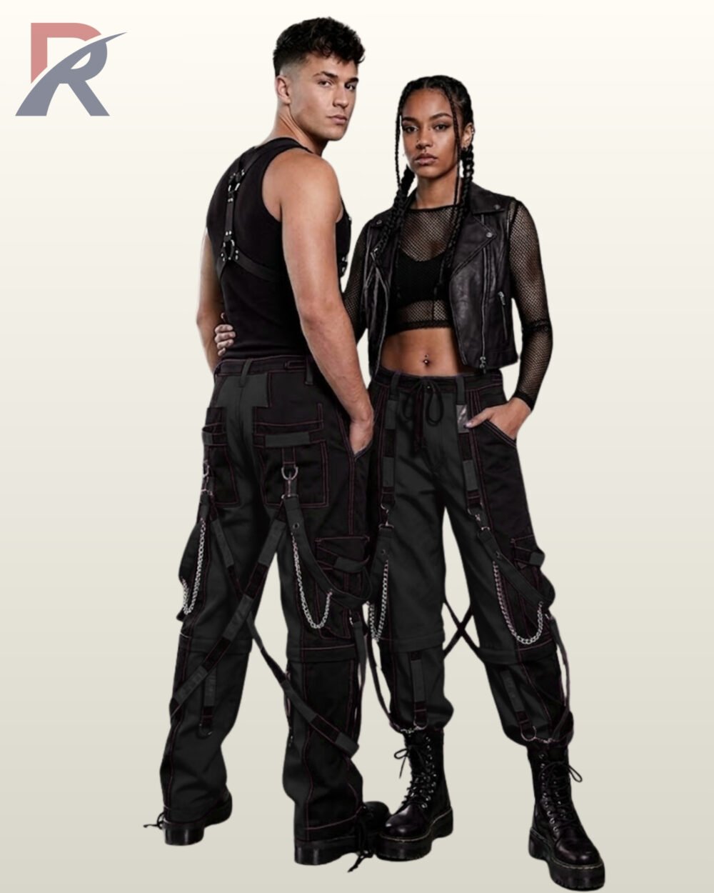 Full model view of a male and female wearing dark charcoal grey and black two-tone gothic bondage cargo pants with dark contrast stitching and metal chains.