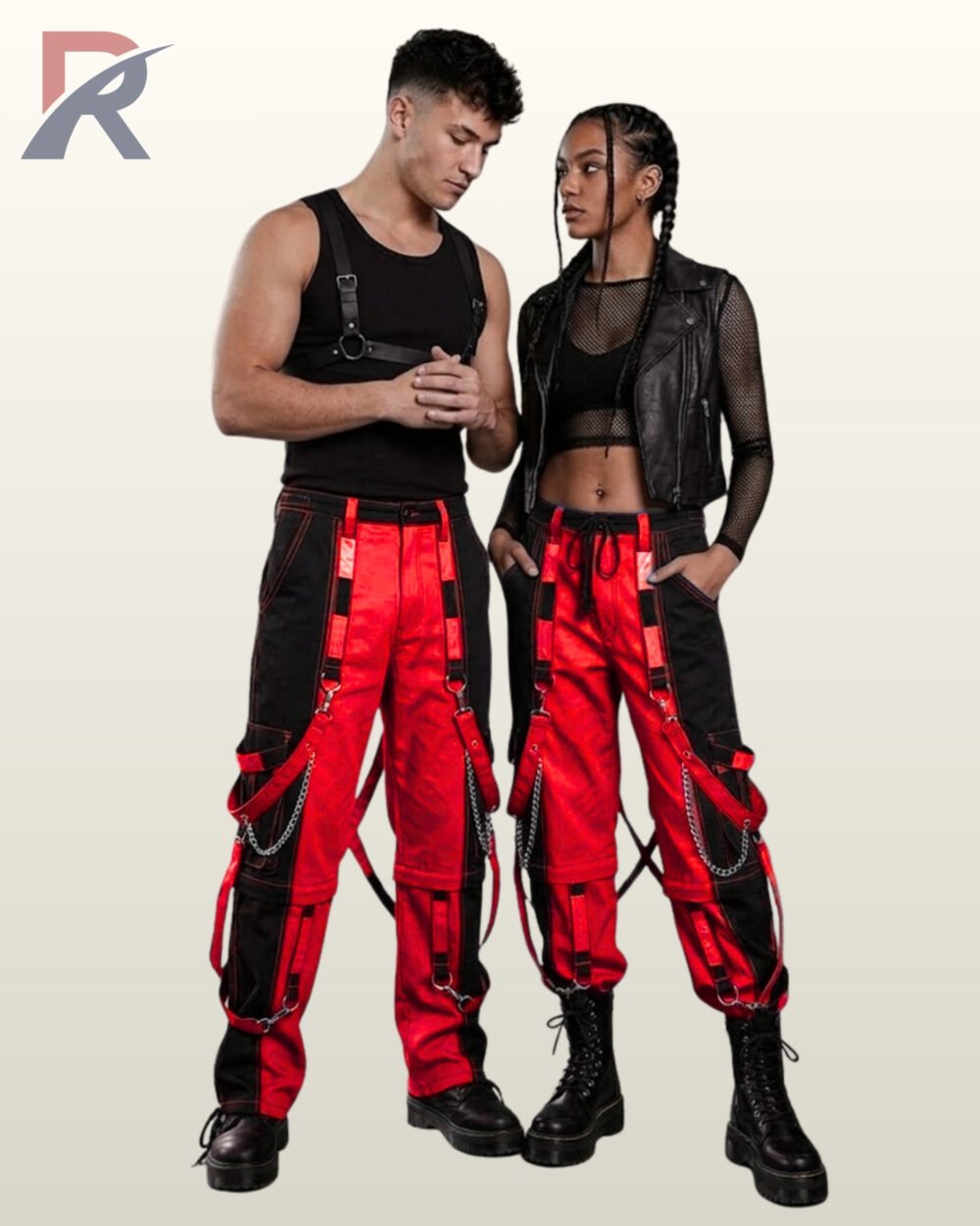 Couples catalog shot of two-tone red and black cyberpunk raver cargo pants featuring hanging bondage straps, silver chains, and platform combat boots.