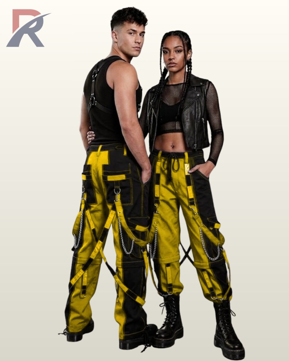 Full model view of a male and female wearing black and bright yellow two-tone gothic bondage cargo pants with silver metal chains and strap accents.
