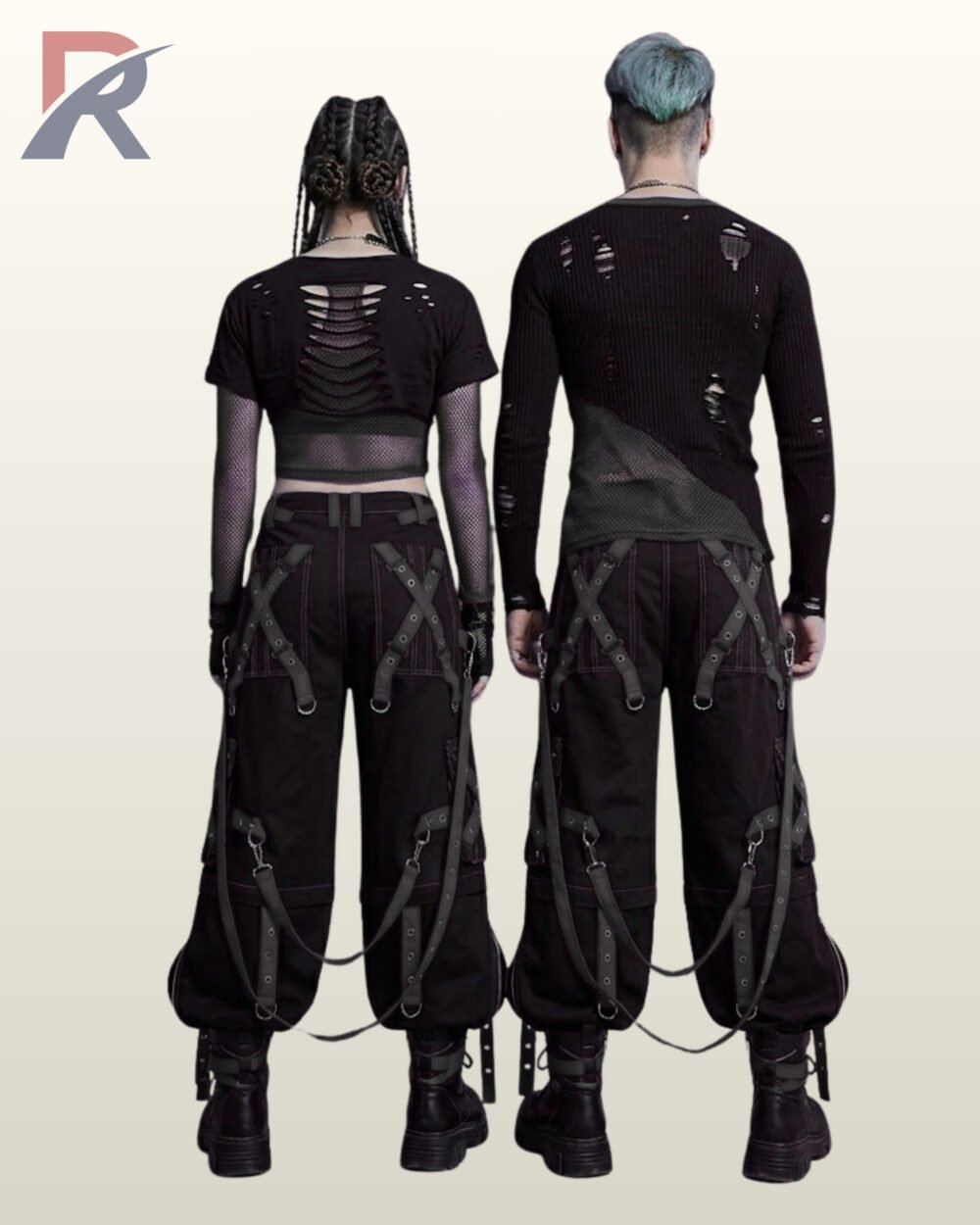 Couples catalog shot of all-black baggy gothic raver trousers featuring dark eyelet leg straps, zipper cargo pockets, hanging D-ring straps, and platform combat boots.