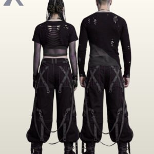 Couples catalog shot of all-black baggy gothic raver trousers featuring dark eyelet leg straps, zipper cargo pockets, hanging D-ring straps, and platform combat boots.