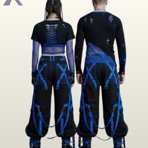 Couples model view of baggy black gothic raver trousers displaying cobalt blue metal-eyelet leg straps, hanging bondage straps, and black leather boots.
