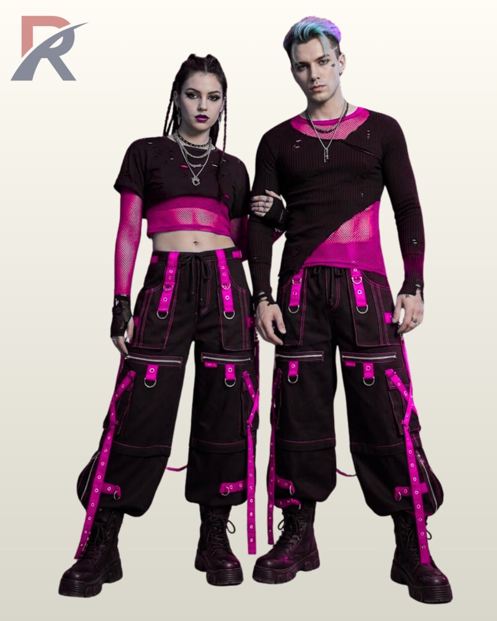 Full front model view of a couple wearing black cyberpunk cargo pants featuring hot magenta pink grommet straps, front zipper pockets, and contrast pink stitching.
