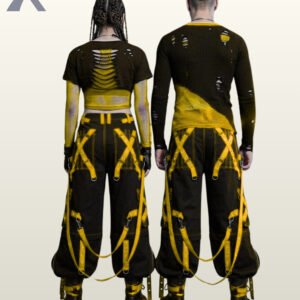 Couples catalog display of baggy black gothic raver trousers with electric yellow metal-eyelet leg straps, side zip pockets, and chunky platform boots.