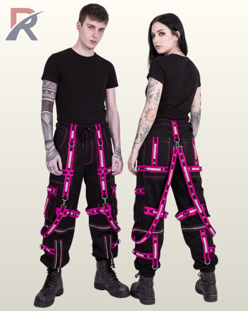Man and woman modeling dark techwear joggers highlighting vibrant hot pink reflective tape and metal hardware.