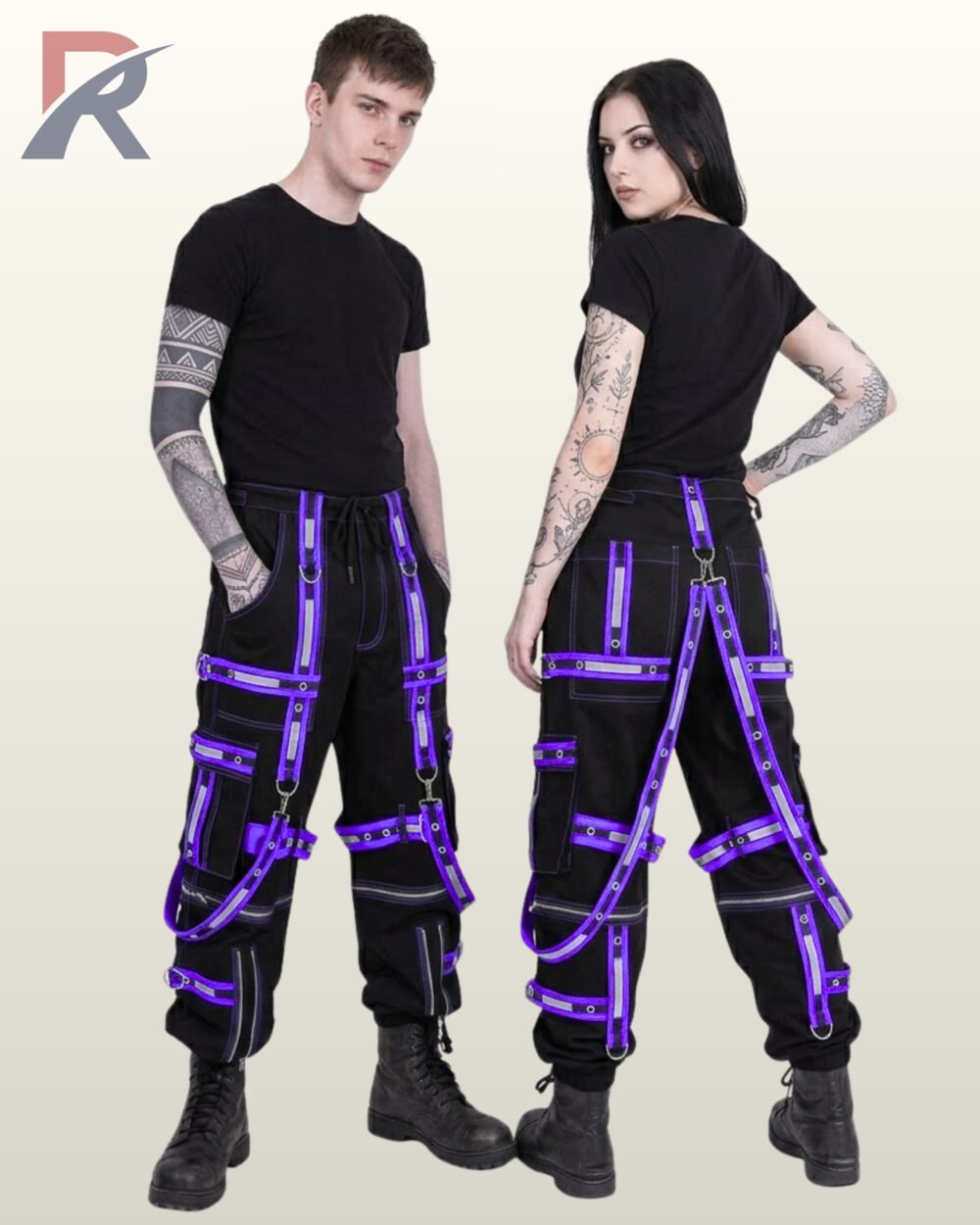 Man and woman posing in alternative darkwear trousers detailed with reflective purple bondage straps and silver metal hardware.
