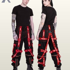 Couple wearing black gothic reflective cargo trousers featuring bold red eyelet straps, suspender harness details, and metal rings.