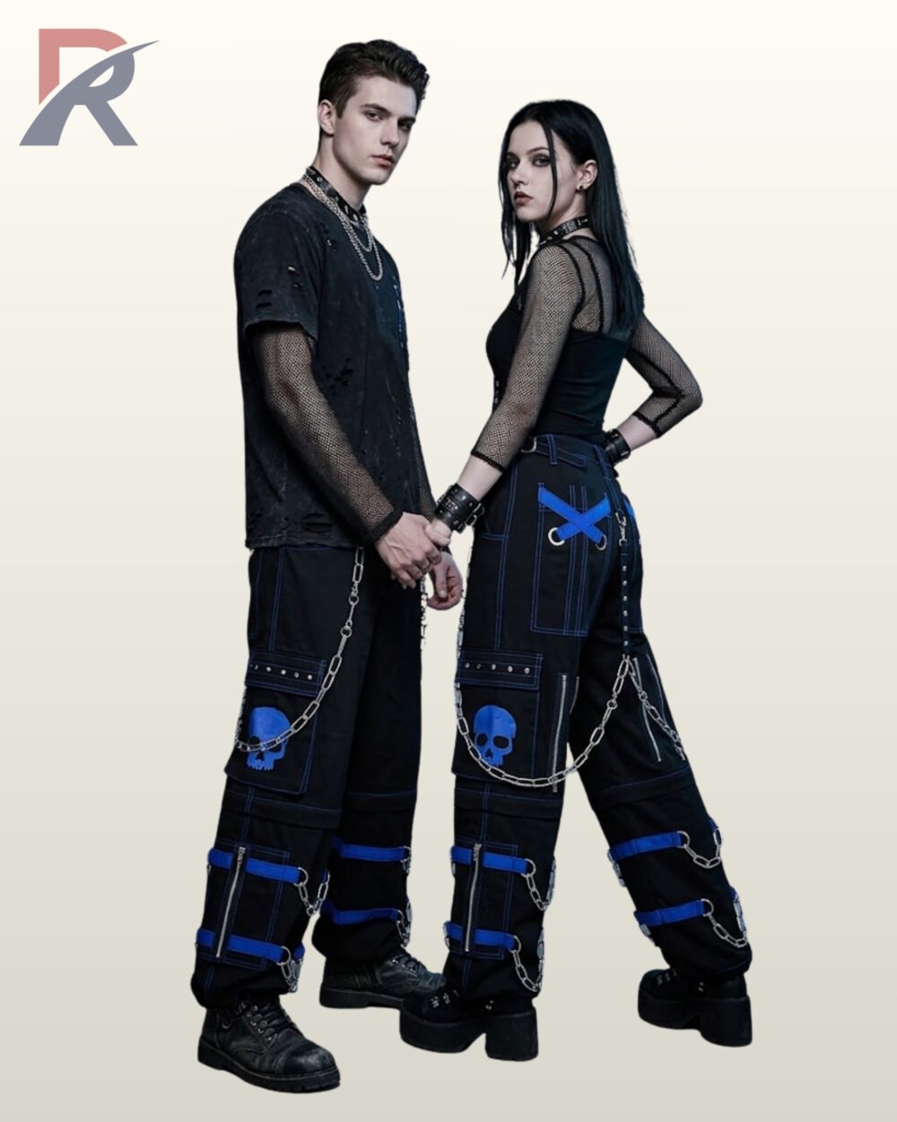 Couples catalog display of black cyberpunk cargo pants featuring cobalt blue buckle leg straps, skull graphics, hanging side chains, and platform boots.