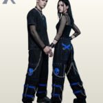 Couples catalog display of black cyberpunk cargo pants featuring cobalt blue buckle leg straps, skull graphics, hanging side chains, and platform boots.