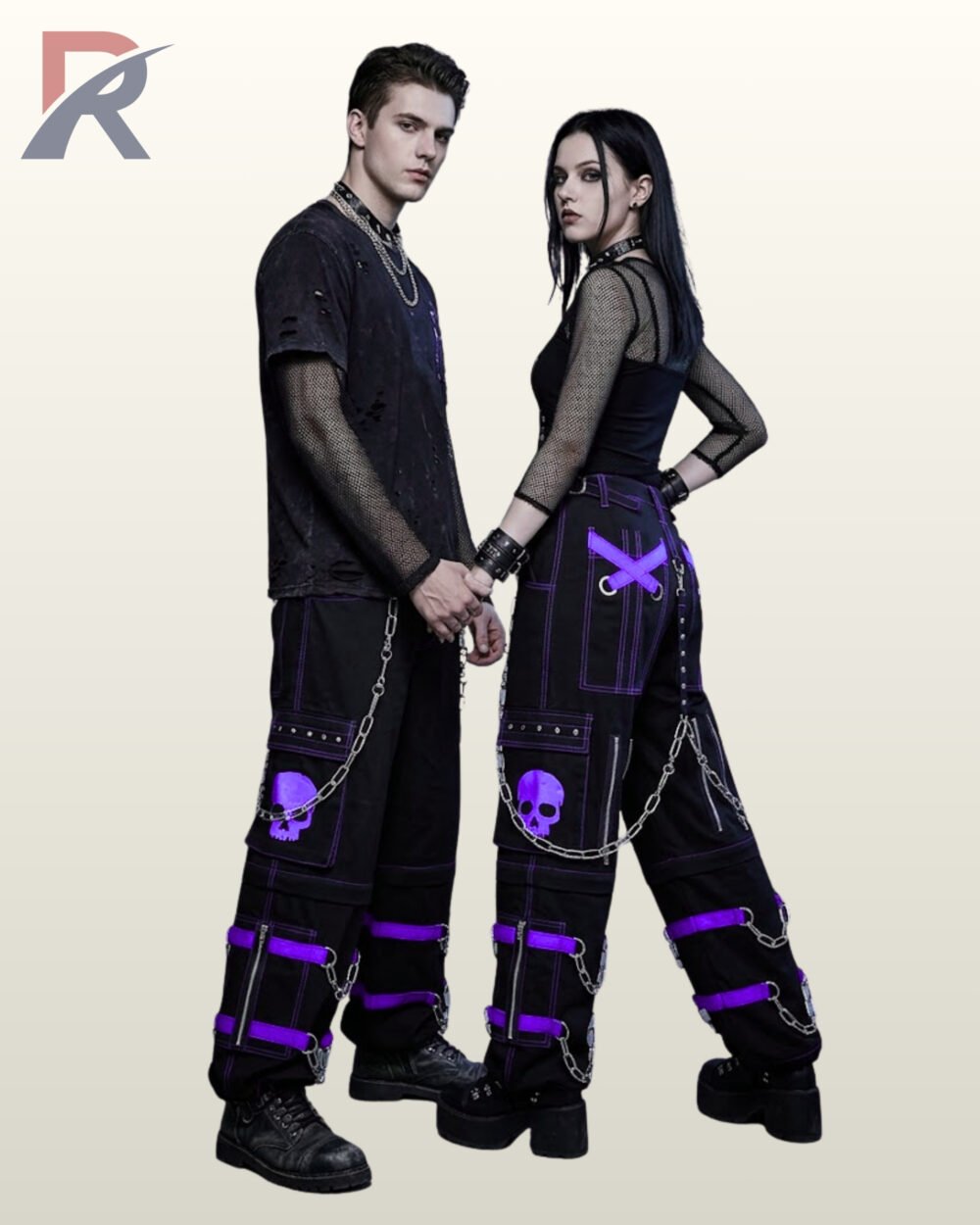 Couples model shot of black cyberpunk cargo trousers displaying royal purple buckle straps, skull graphics, side zippers, and hanging silver metal chains.