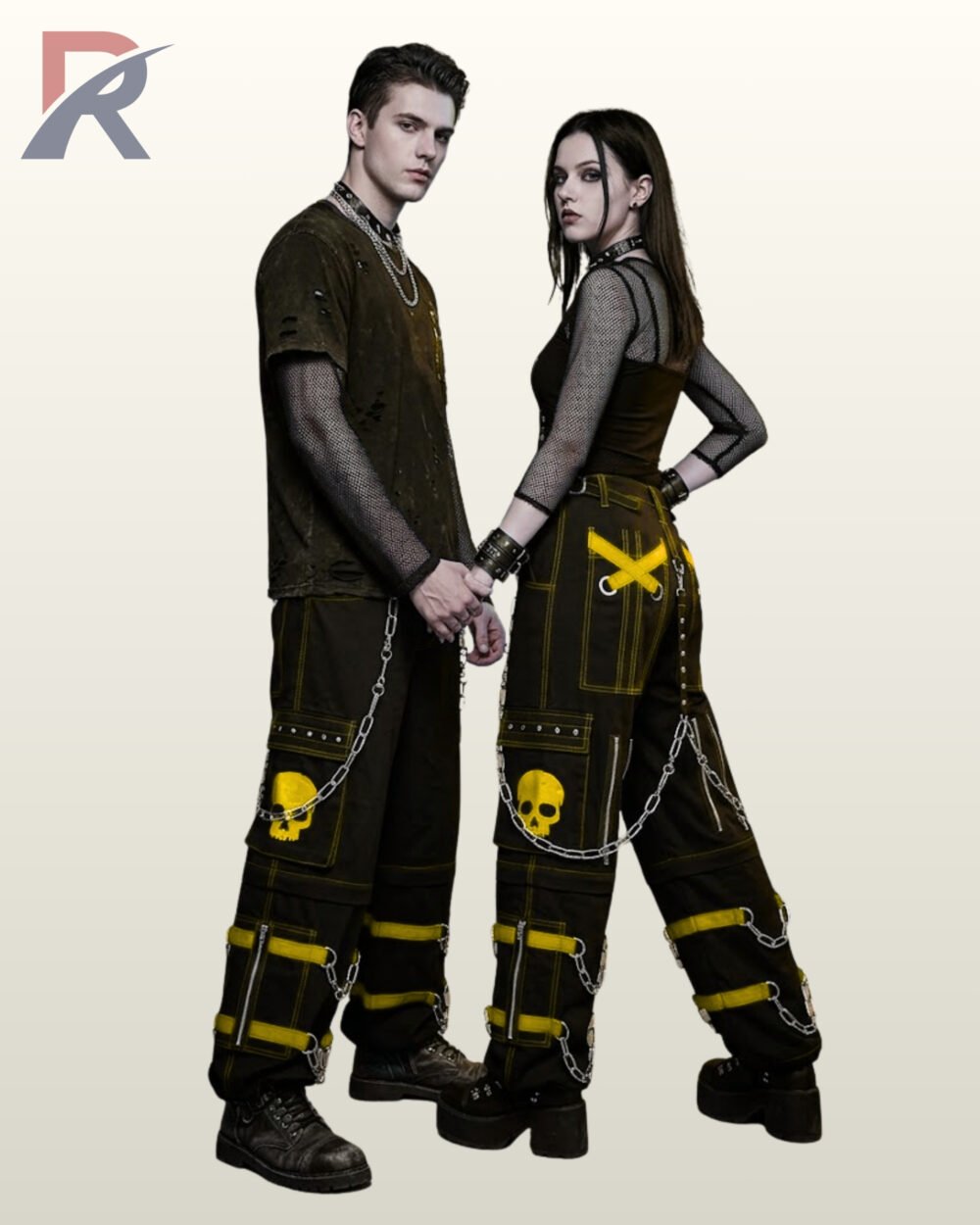 Full model view of a male and female wearing black gothic skull cargo pants with yellow accent stitching, yellow skull patch pockets, and hanging metal chains.