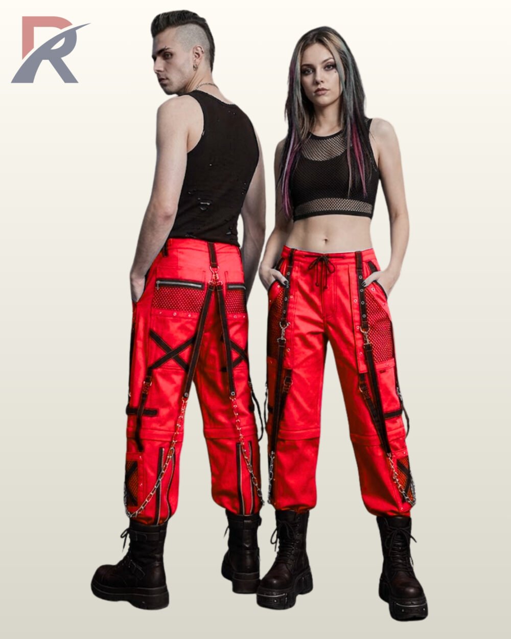 Man and woman holding hands in red alternative streetwear trousers featuring black straps, D-rings, and hanging metal chains.