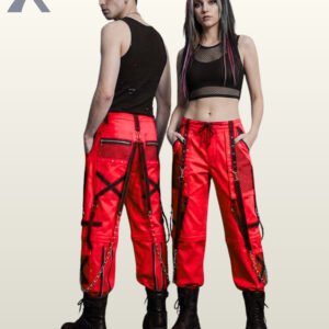Man and woman holding hands in red alternative streetwear trousers featuring black straps, D-rings, and hanging metal chains.