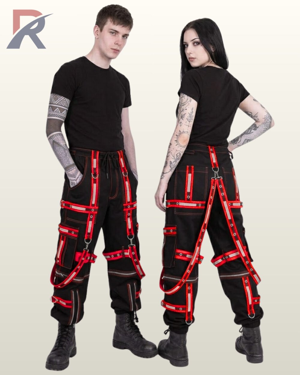 Man and woman modeling industrial goth techwear trousers detailed with red high-visibility reflective straps and D-rings.