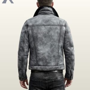 A close-up shot of a man modeling a vintage grey suede trucker jacket featuring a black fur collar.