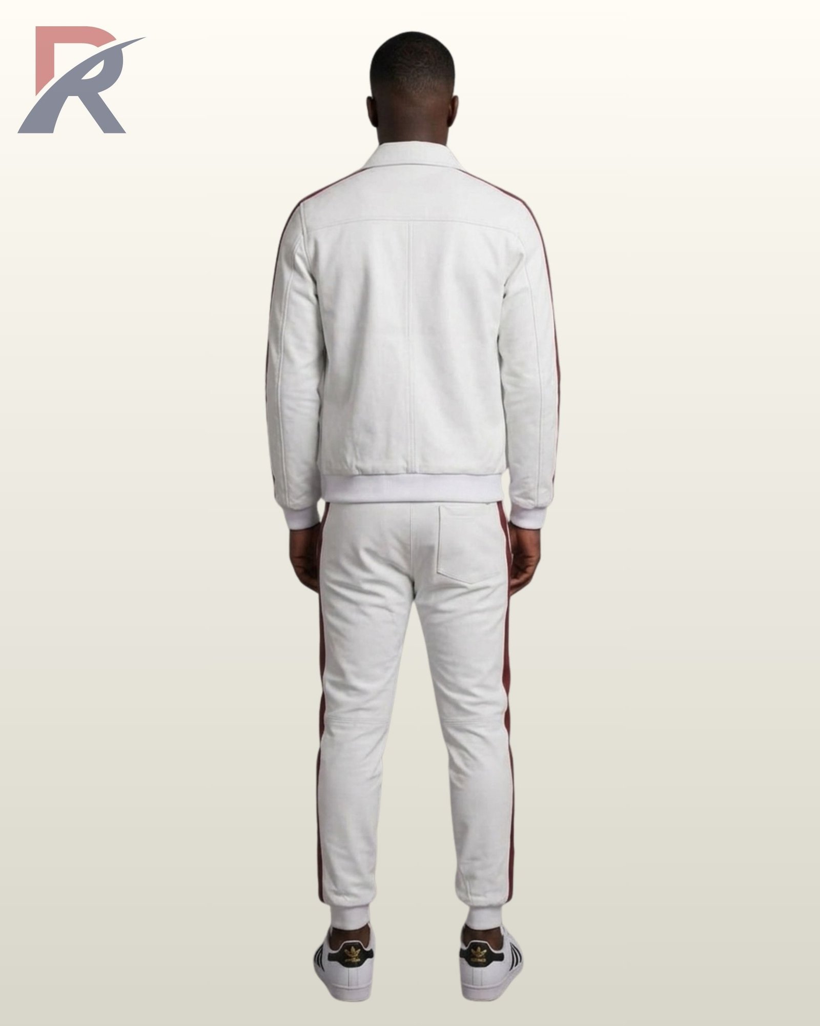 A stylish men's white varsity-style tracksuit with burgundy side stripes, paired with white sneakers.