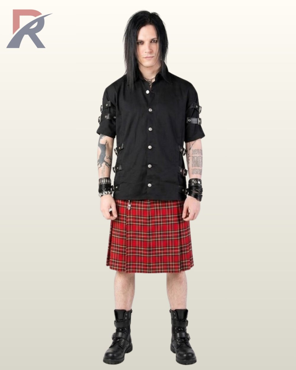 Full front model view of a long-haired man wearing a black short-sleeve gothic shirt featuring sleeve and side-waist buckle straps styled with a traditional red tartan kilt.
