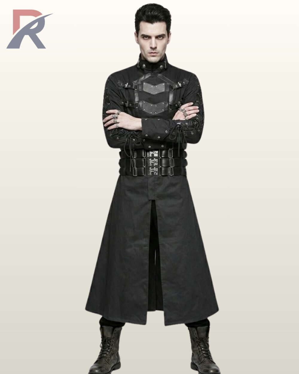 Male model with arms crossed wearing a floor-length black industrial gothic coat with standing collar, metal eyelet sleeve lacing, and combat boots.