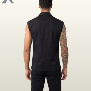 Full rear view of a male model with a tattoo sleeve wearing a black sleeveless gothic biker vest and matching dark trousers.