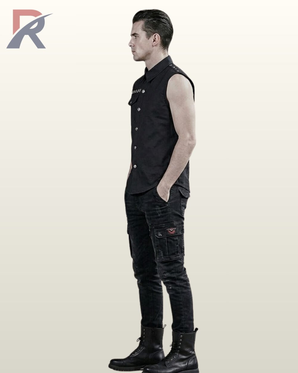 Side profile view of a male model wearing a black sleeveless gothic button-down shirt with metallic shoulder rivets, paired with distressed black cargo pants and leather boots.