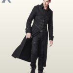 Three-quarter walking model view of a men's black gothic long coat showing flowing skirt panels, shoulder strap details, and front buckle chest straps.