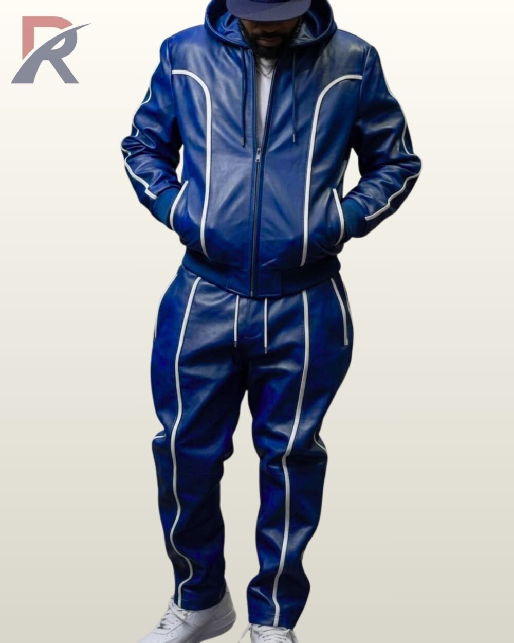 Man wearing a royal blue 2-piece leather tracksuit set with a hooded zip jacket and trousers detailed with white piping.