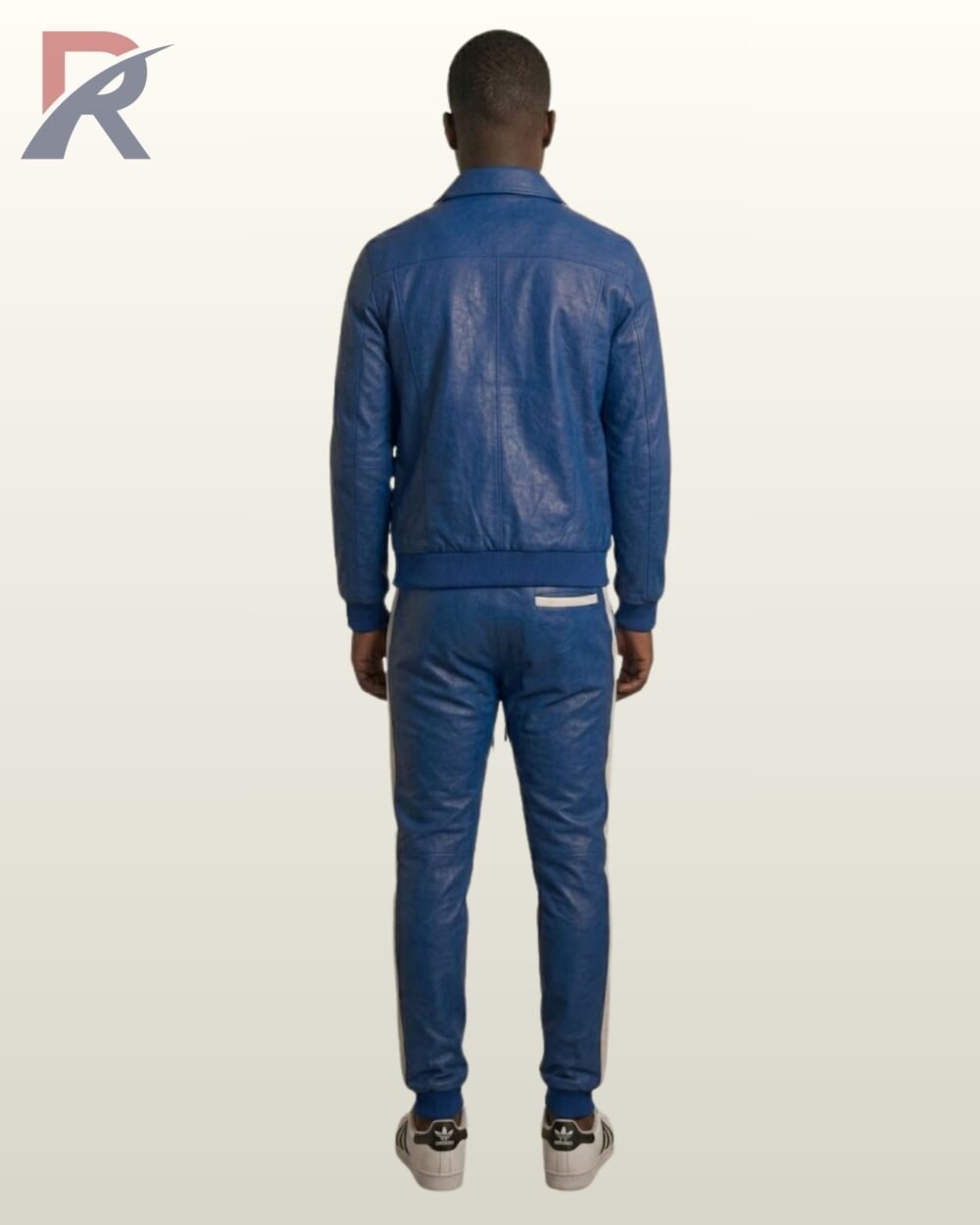 A model posing in a cobalt blue leather button-up jacket and matching joggers.