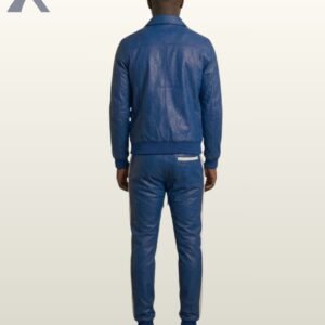 A model posing in a cobalt blue leather button-up jacket and matching joggers.