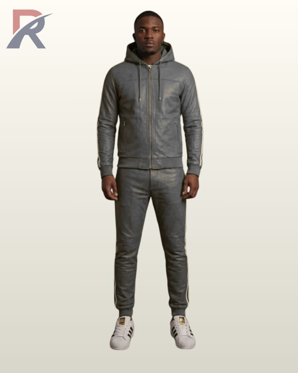 A designer dark gray leather activewear suit paired with white casual sneakers.