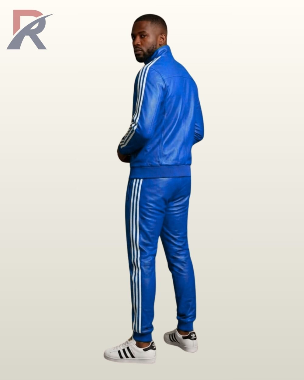 A designer bright blue leather sweat suit set worn with white casual trainers.