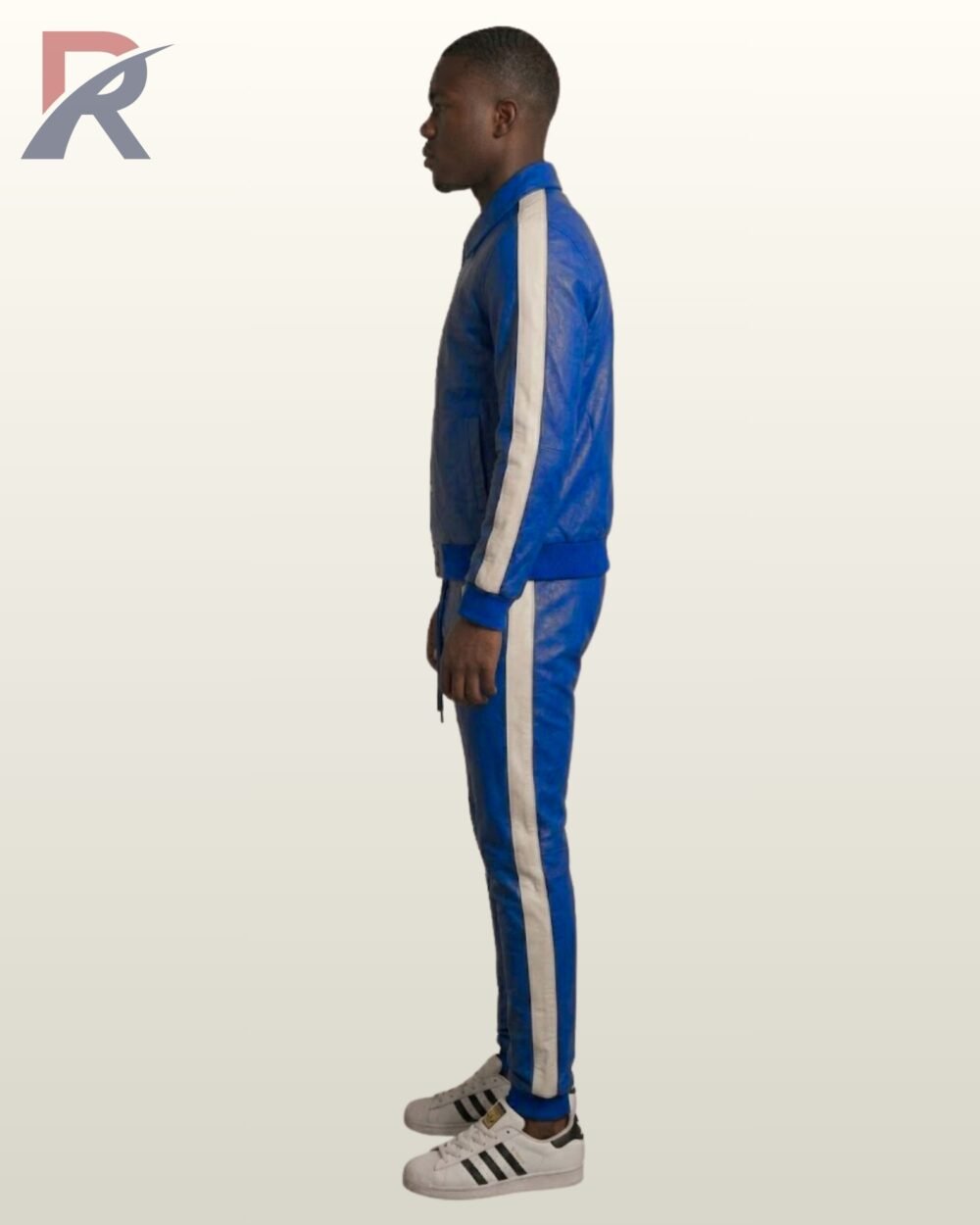 A man wearing a royal blue leather tracksuit with white side stripes.