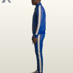 A man wearing a royal blue leather tracksuit with white side stripes.