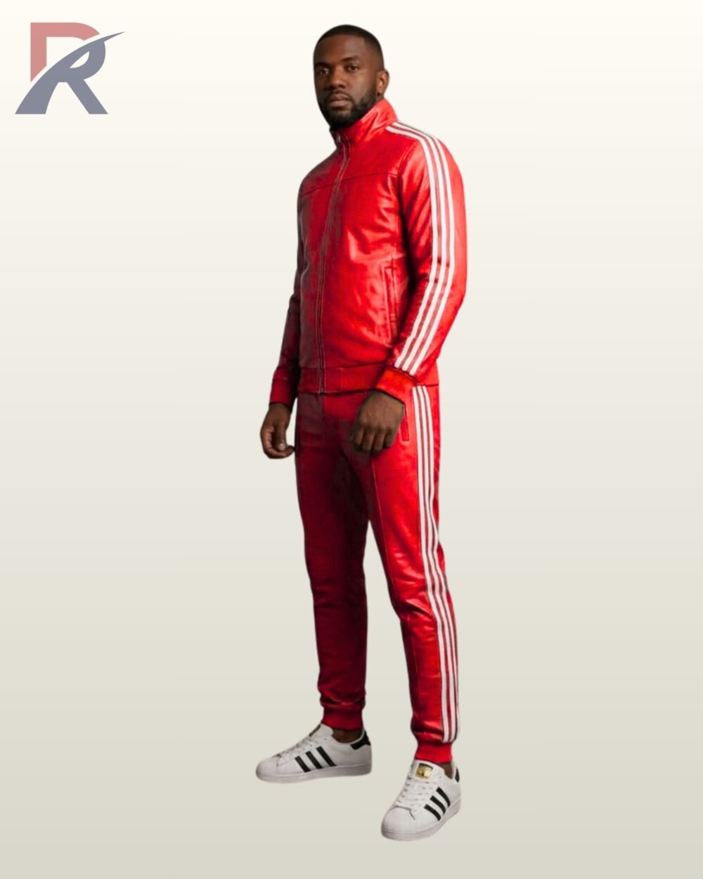 A full-length view of a man modeling a vibrant red leather tracksuit with classic white athletic stripes.