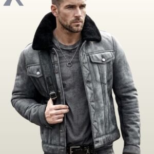 A model wearing a premium washed grey suede winter jacket with black fleece lining on the collar.
