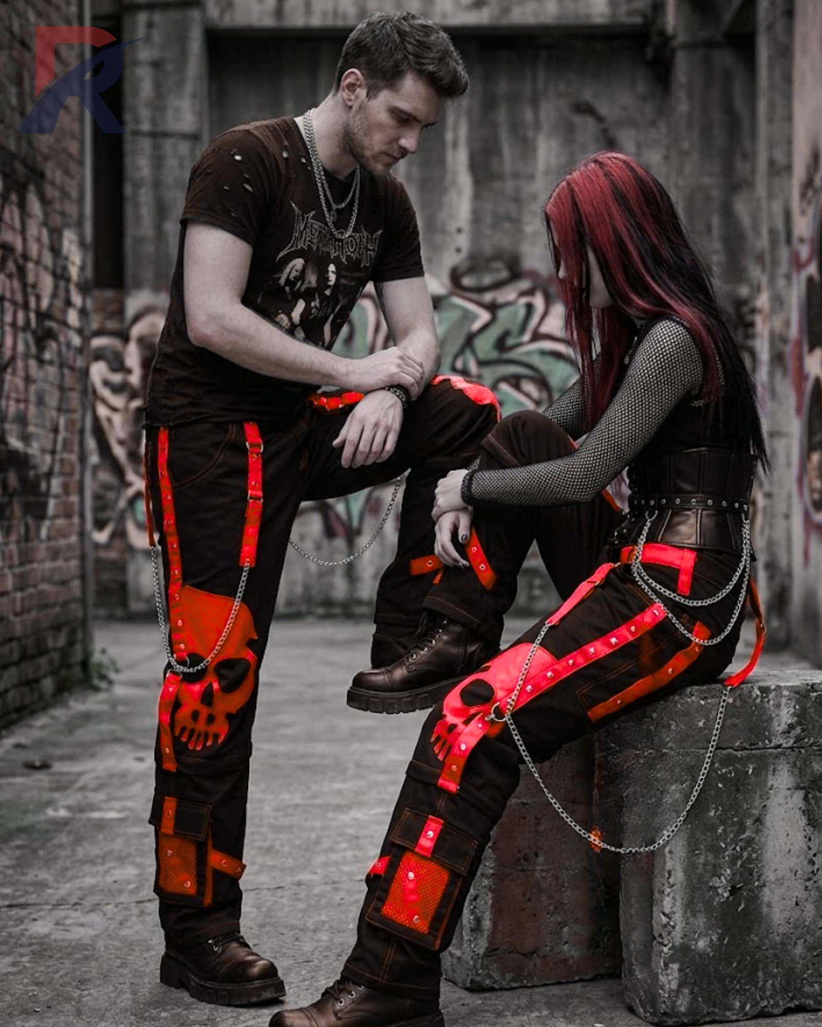 Darkwear loose black bondage trousers featuring red accent straps and hanging metal chain accents.