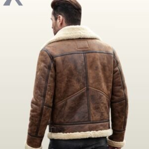 A model wearing a premium distressed brown leather winter bomber jacket with soft cream fleece lining.