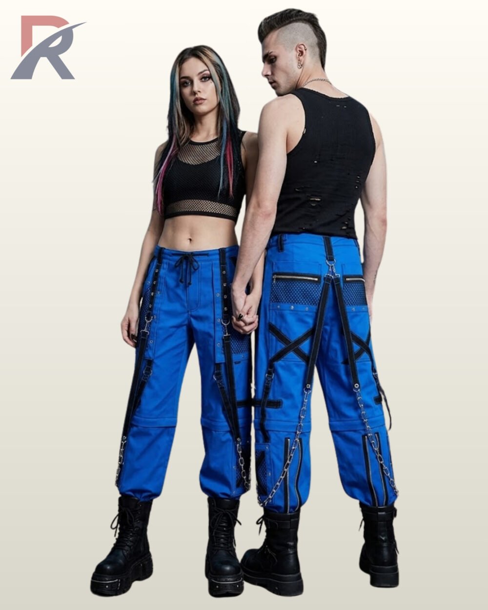 Man and woman holding hands in electric blue cyber goth trousers detailed with black straps, metal D-rings, and chains.