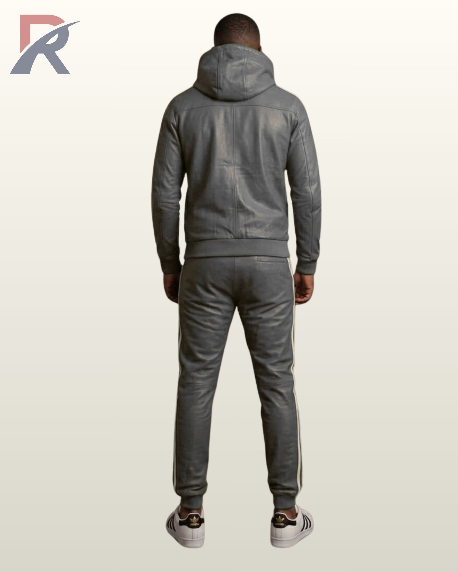 A man modeling a charcoal gray leather hoodie and sweatpants set with white trim