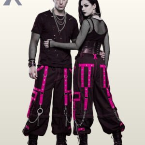 Gothic couple posing in baggy black cargo trousers featuring hot pink eyelet straps and silver chains.