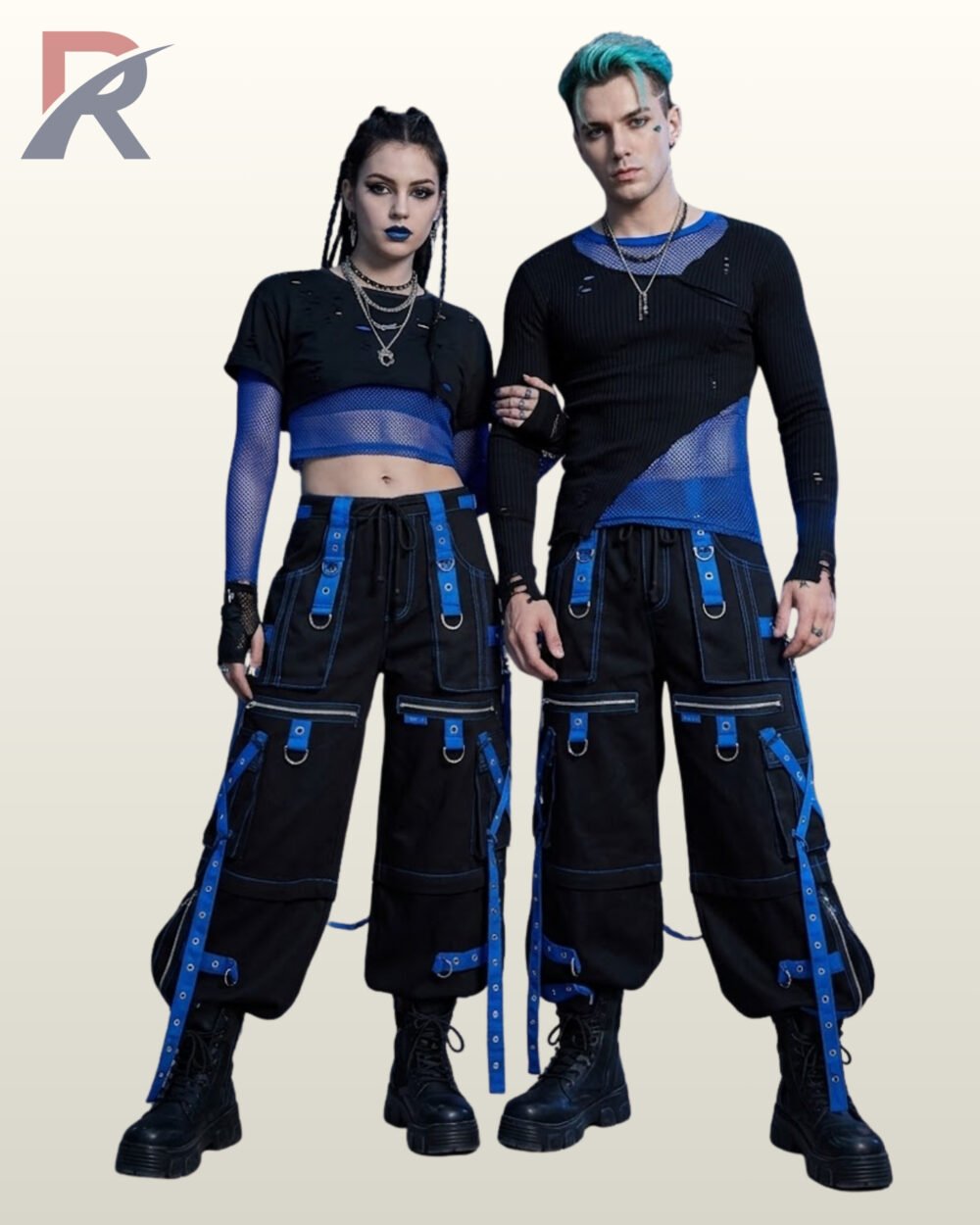 Full front model view of a couple wearing black cyberpunk cargo pants featuring royal electric blue grommet straps, zipper thigh pockets, and contrast blue stitching.