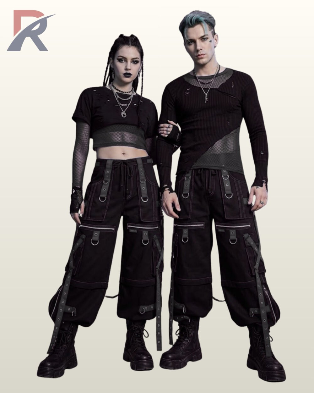Full front model view of a male and female wearing monochromatic black and charcoal grey cyberpunk cargo pants with black grommet straps and dark contrast stitching.