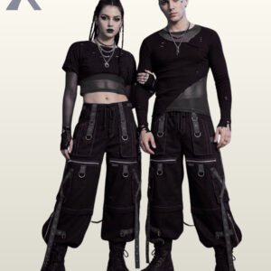 Full front model view of a male and female wearing monochromatic black and charcoal grey cyberpunk cargo pants with black grommet straps and dark contrast stitching.