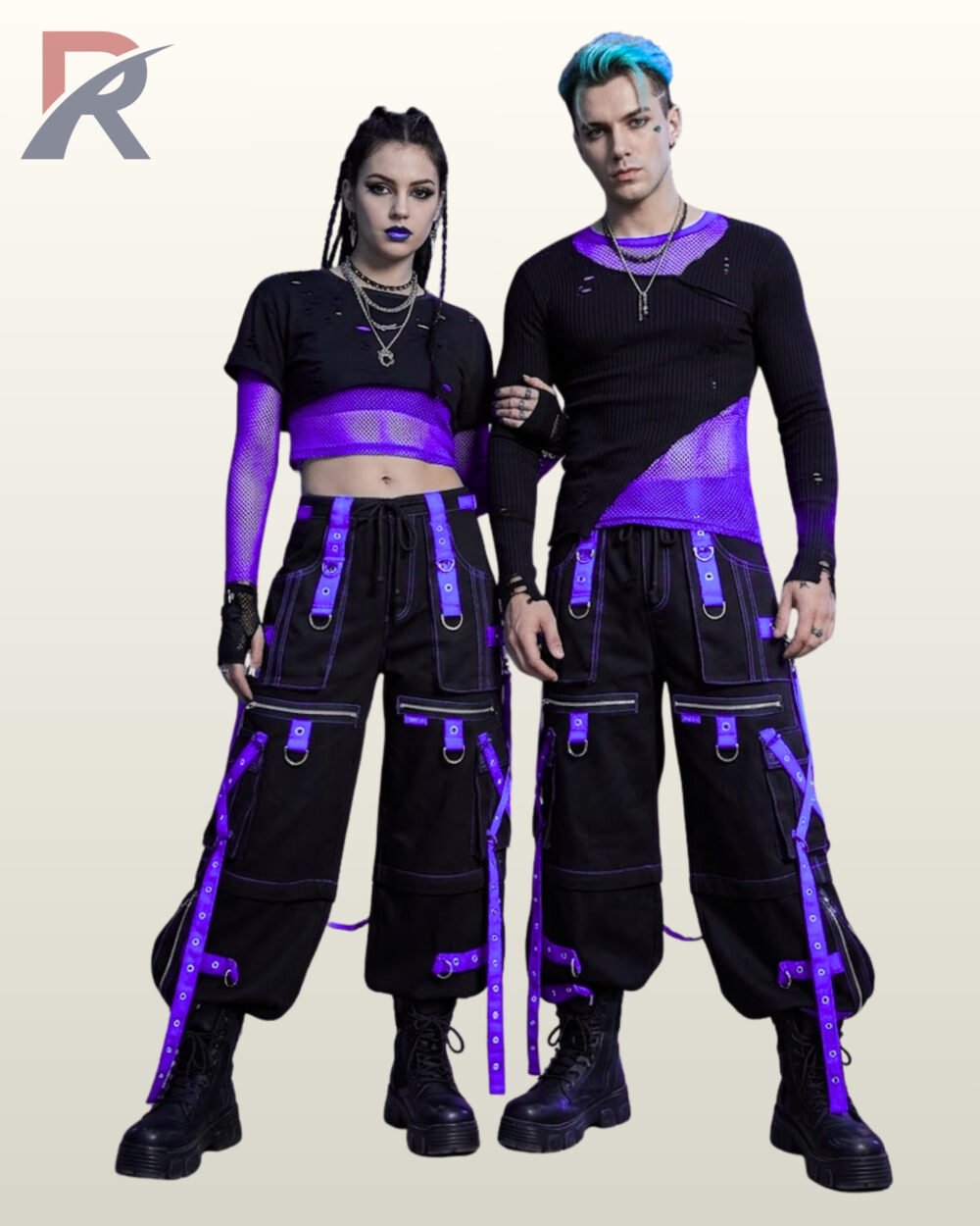 Couples model view of baggy black gothic raver trousers featuring vibrant purple metal-eyelet leg straps, hanging D-ring straps, and chunky platform boots.