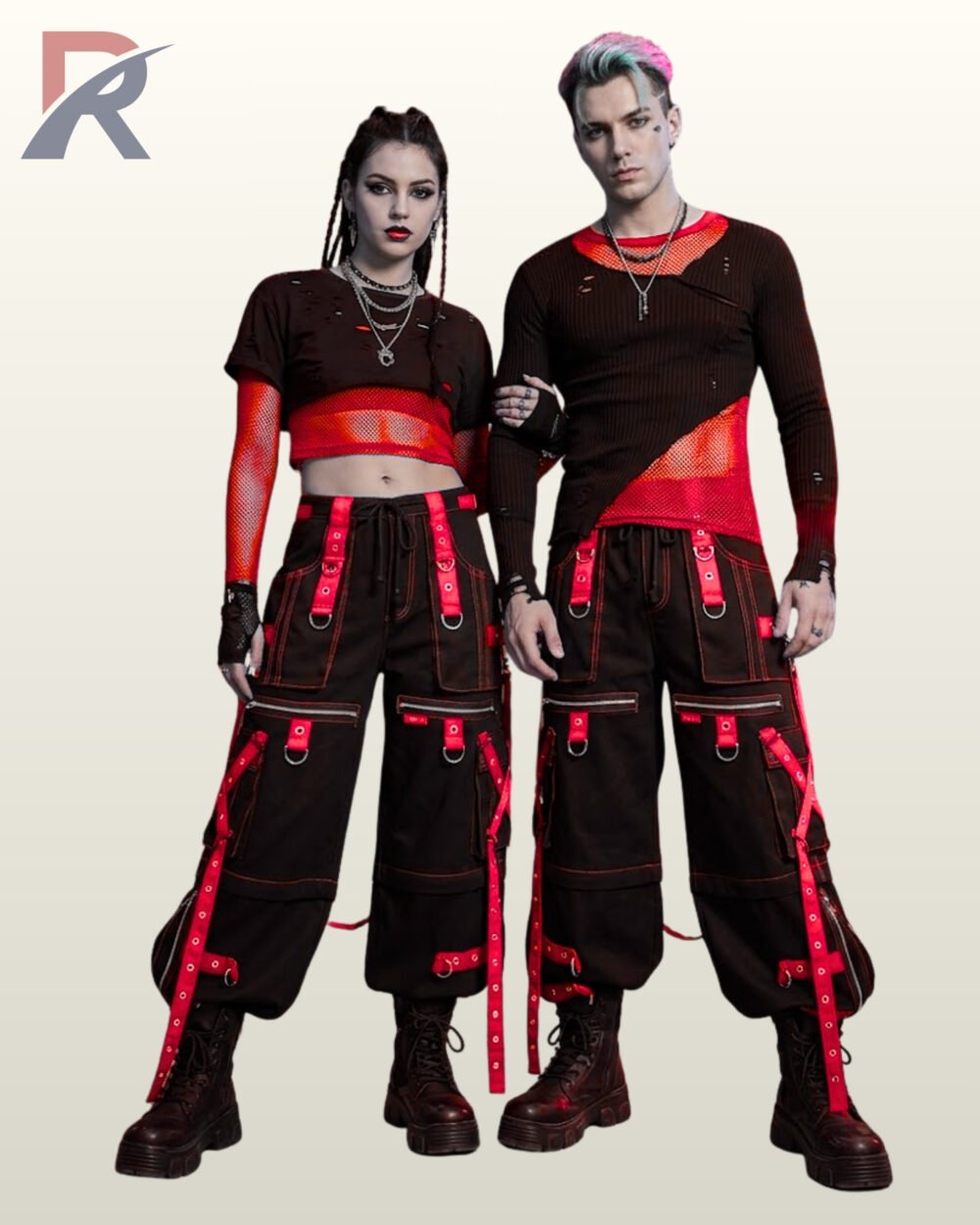 Full front model view of a male and female wearing black cyberpunk cargo pants featuring crimson red grommet straps, contrast red stitching, and hanging bondage straps.