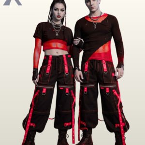 Full front model view of a male and female wearing black cyberpunk cargo pants featuring crimson red grommet straps, contrast red stitching, and hanging bondage straps.