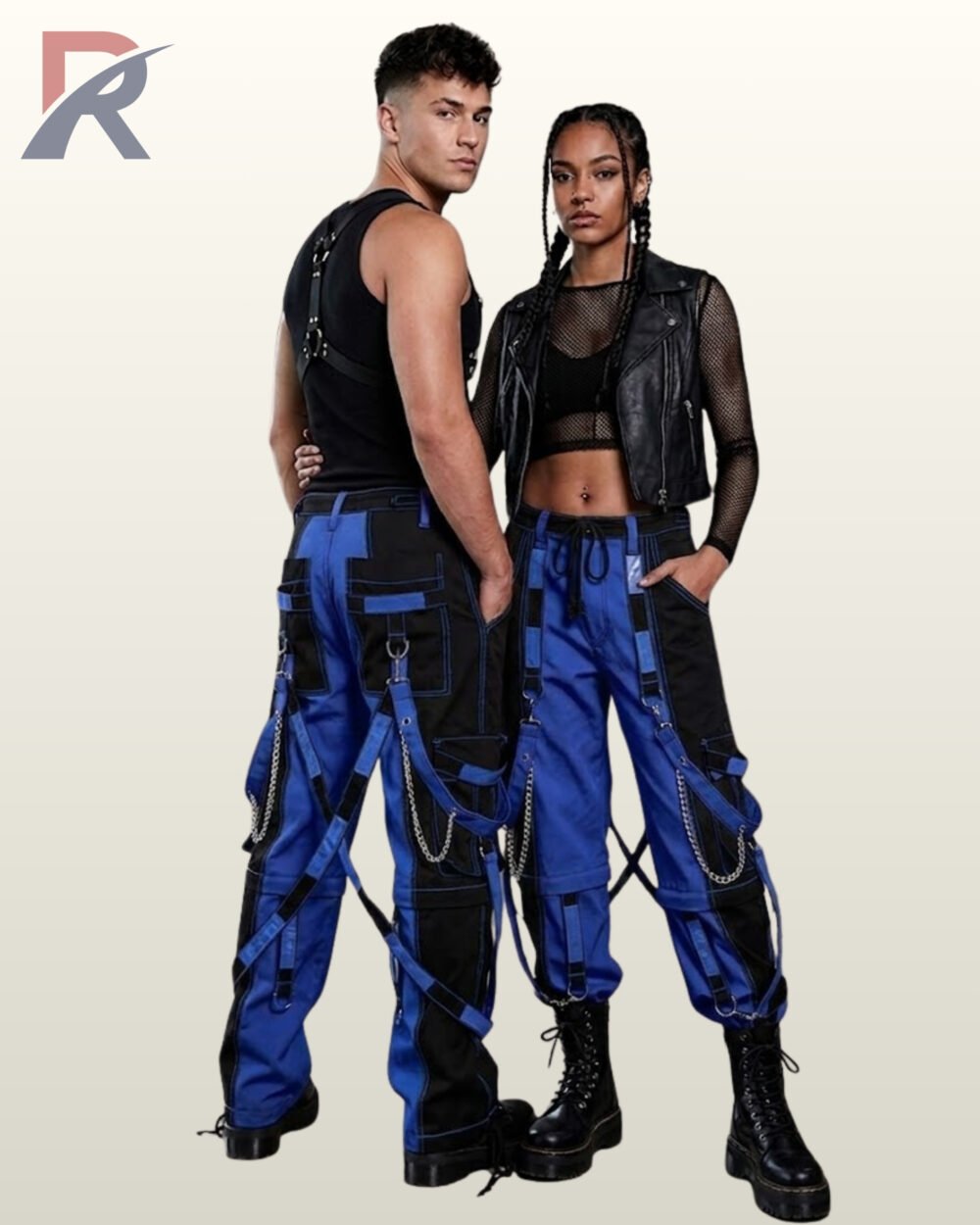 Couples model shot of two-tone blue and black cyberpunk cargo trousers featuring contrast stitching, hanging leg straps, and platform combat boots.