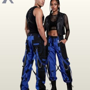 Couples model shot of two-tone blue and black cyberpunk cargo trousers featuring contrast stitching, hanging leg straps, and platform combat boots.